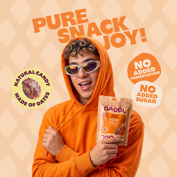 Guy in orange hoodie holding sour cola daddl bag in photo shot