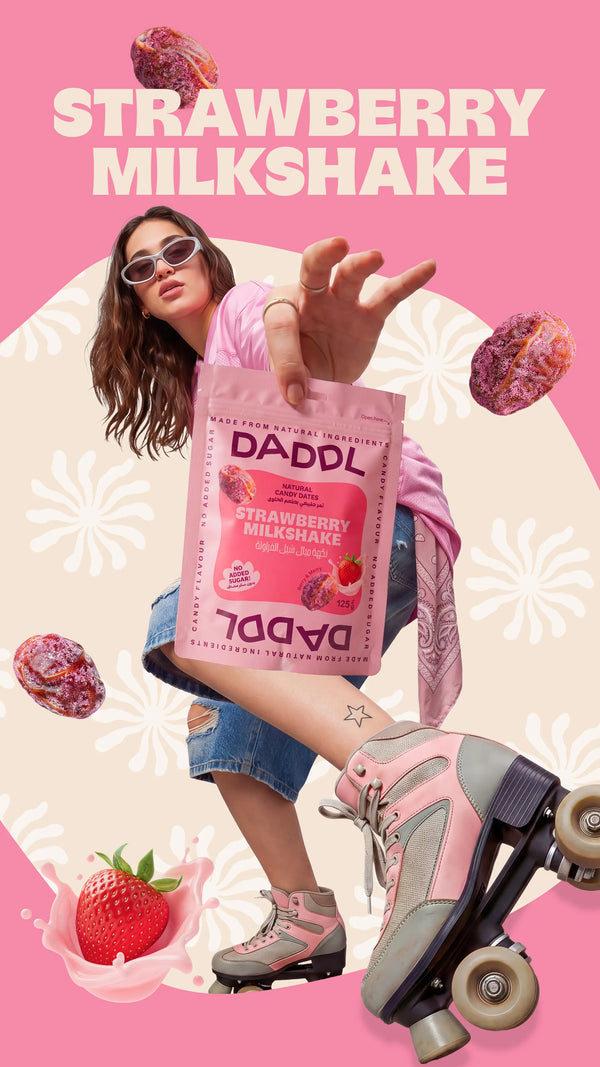 Young woman on roller skates reaching toward the camera while holding a DADDL Strawberry Milkshake candy dates pouch against a pink background with large “STRAWBERRY MILKSHAKE” text, floating coated dates, and strawberry splash graphics.