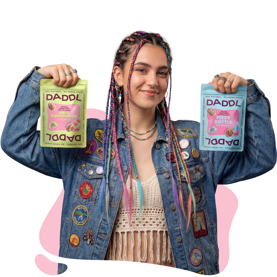 Girl holding 2 DADDL date candy bags