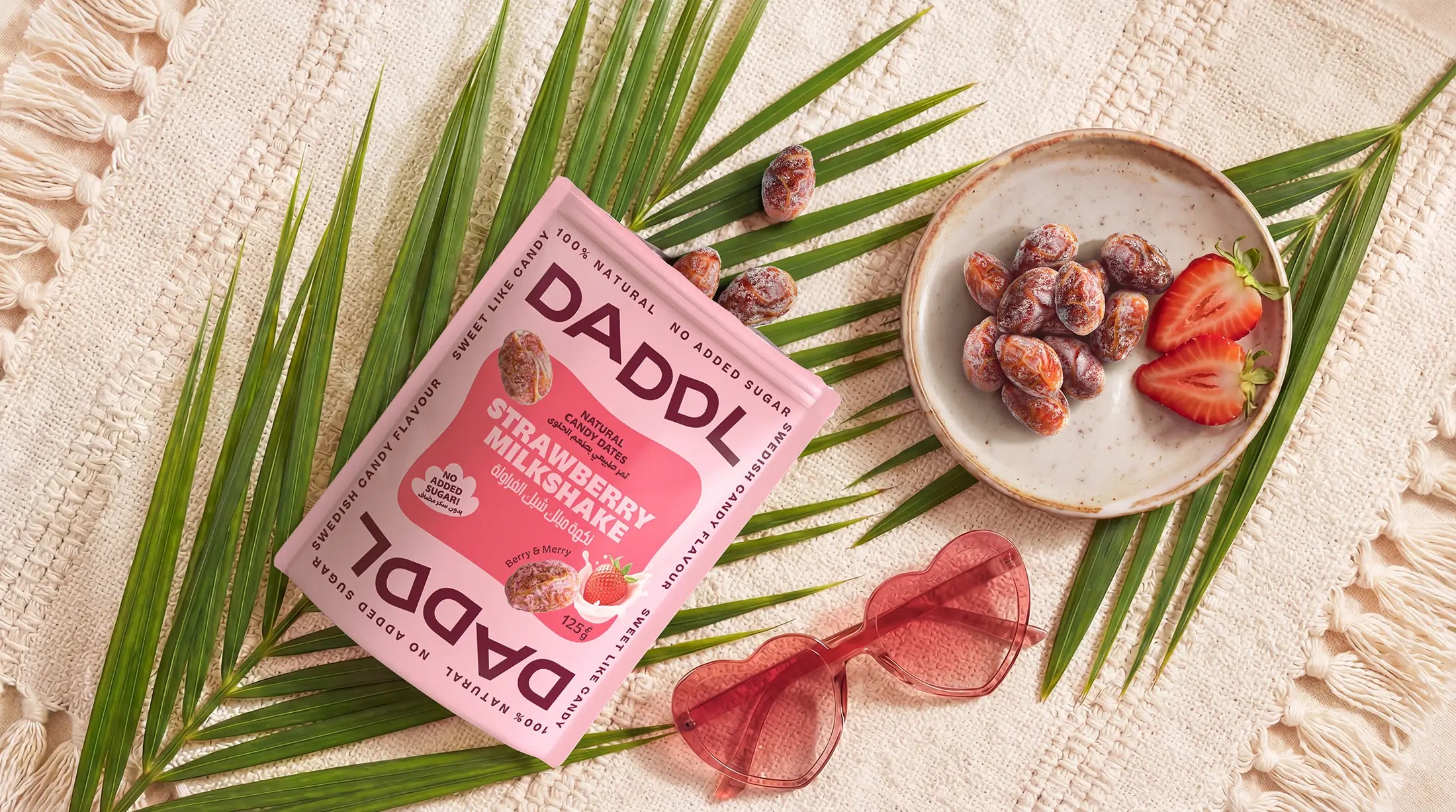 DADDL strawberry milkshake package with a bowl of strawberries and chocolate on a leafy background