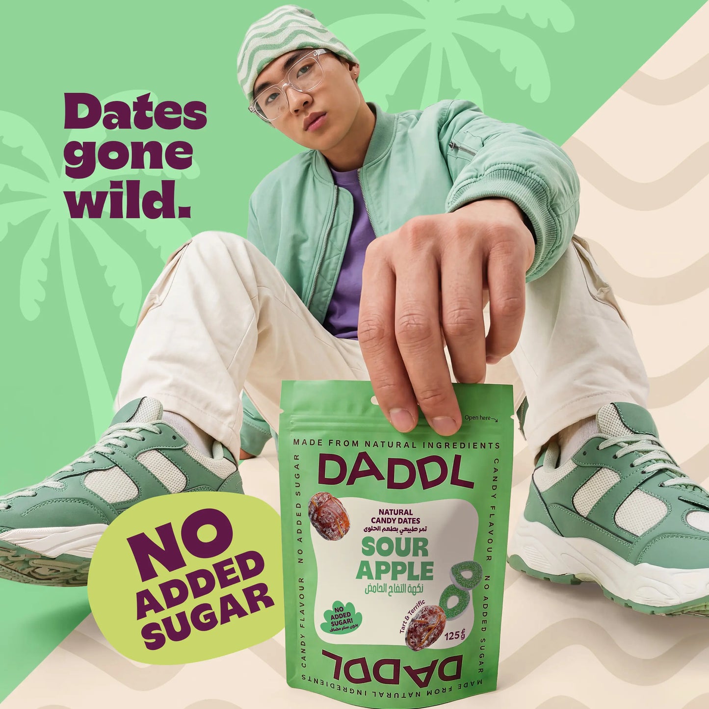 Person holding a DADDL natural candy dates package with text 'Dates gone wild. No added sugar' on a green background.