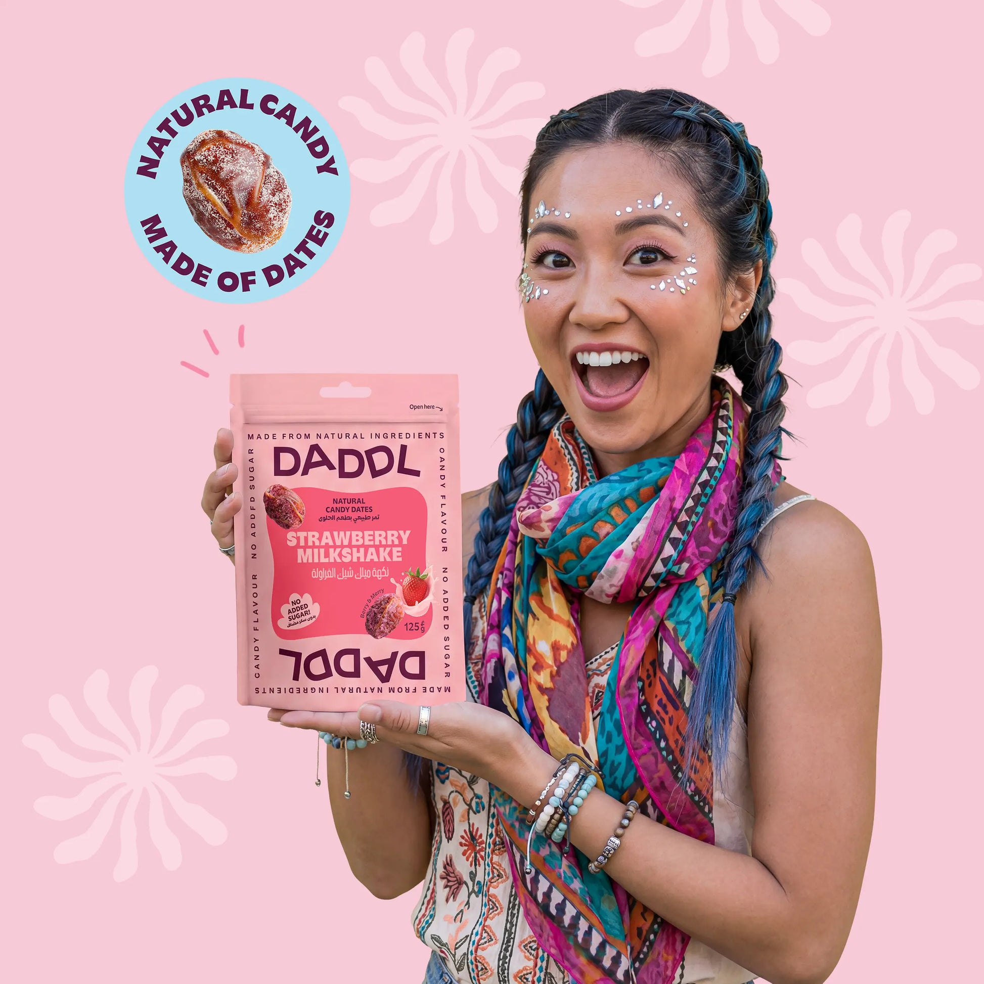 Woman holding a DADDL strawberry milkshake package against a pink background with DADDL branding.